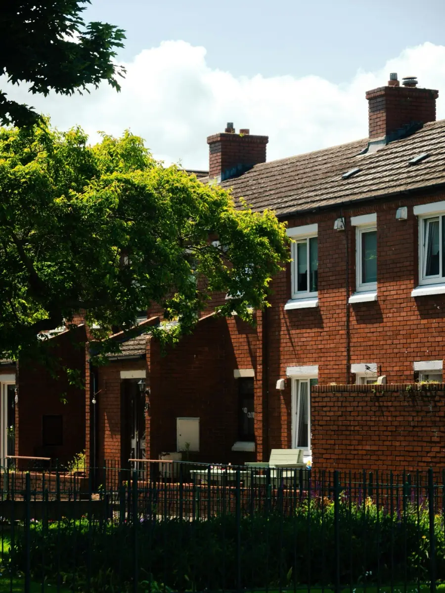A sunny row of brick homes on a quiet street